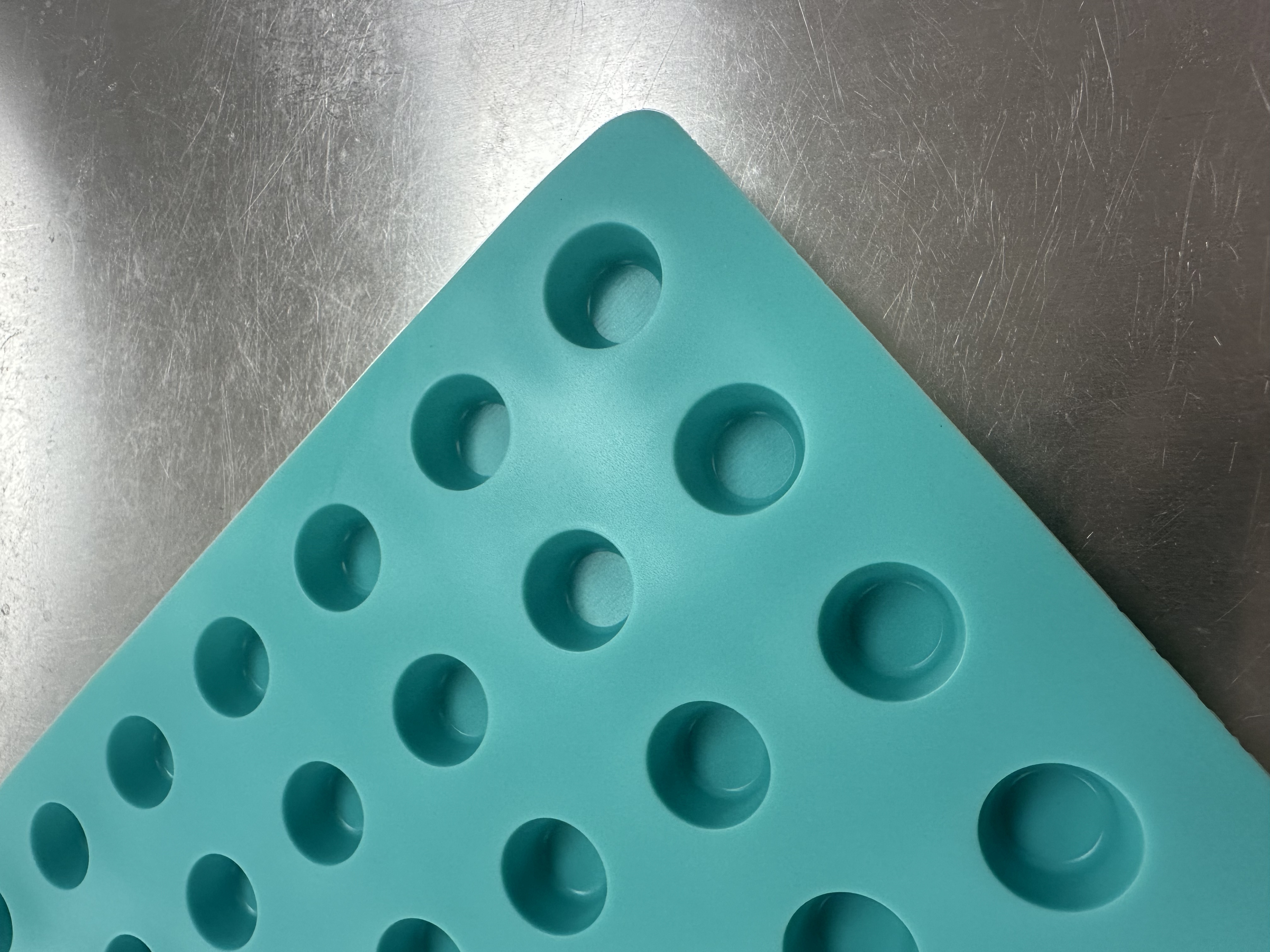 Angled close-up of flat-top dome cavities on Product 009